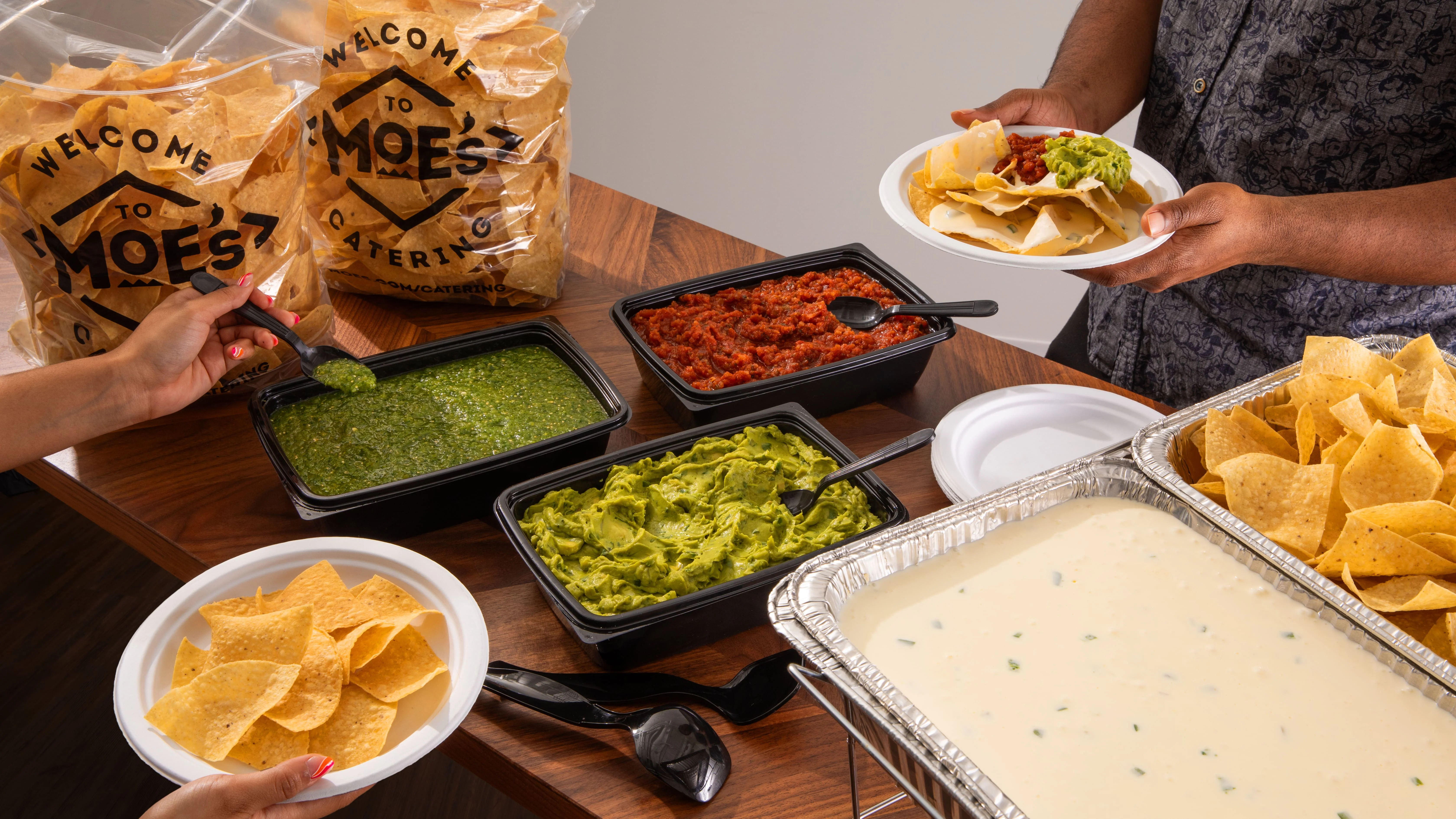 Moe's nacho bar catering setup for a large office gathering
